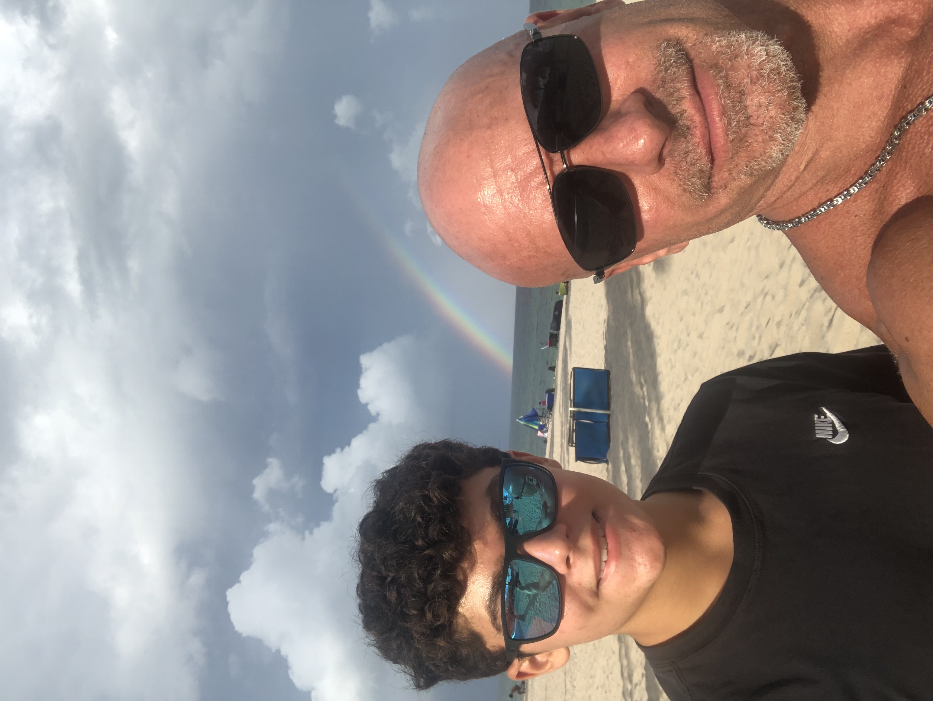Steven Panzella with his son at the beach with rainbow